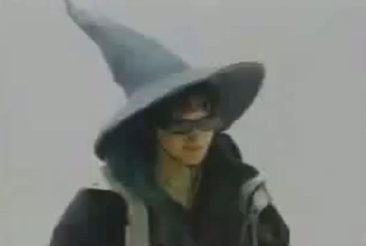 a blurry image of a woman wearing a witches hat