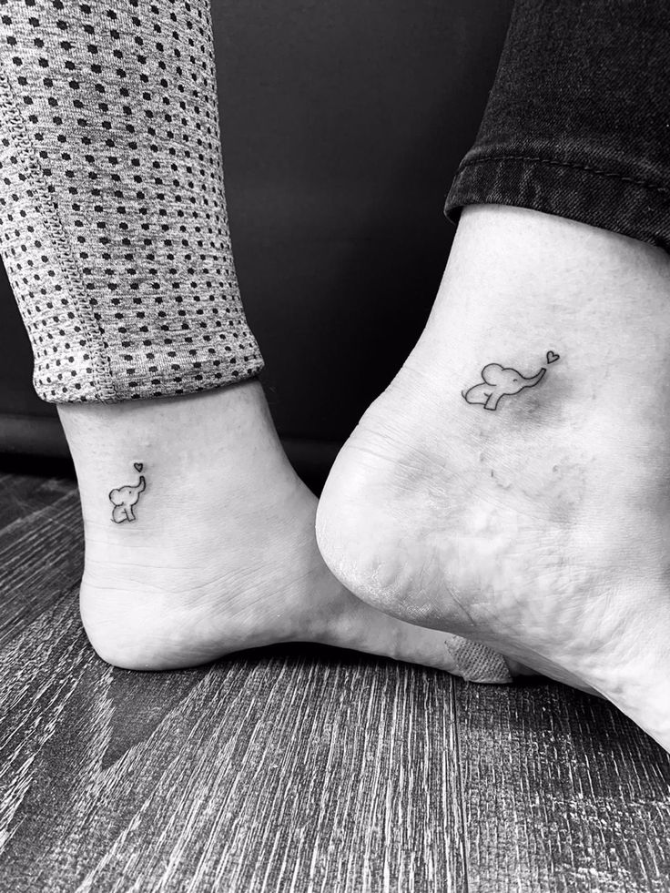 two people with matching tattoos on their feet, one has a dog and the other has a cat