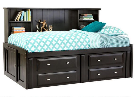 a bed with two drawers underneath it and a book shelf above the headboard,