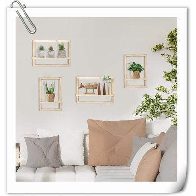 a living room filled with white couches and potted plants on top of them