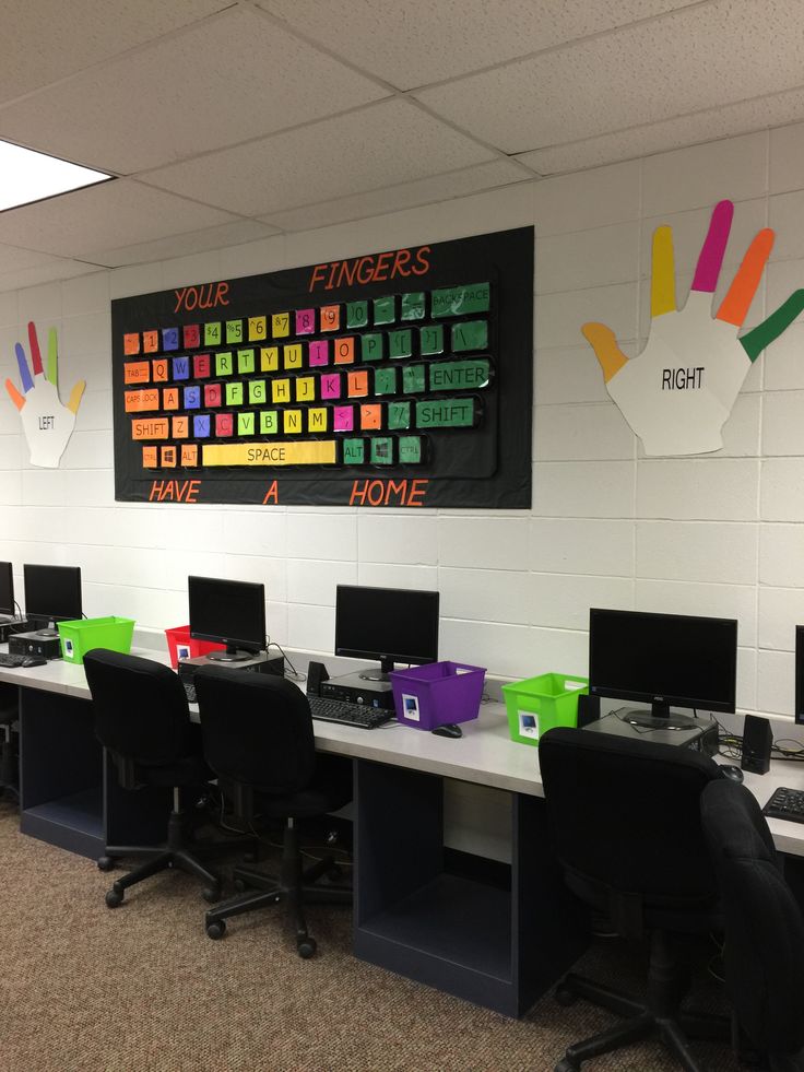 an office cubicle with several computers and hand prints on the wall