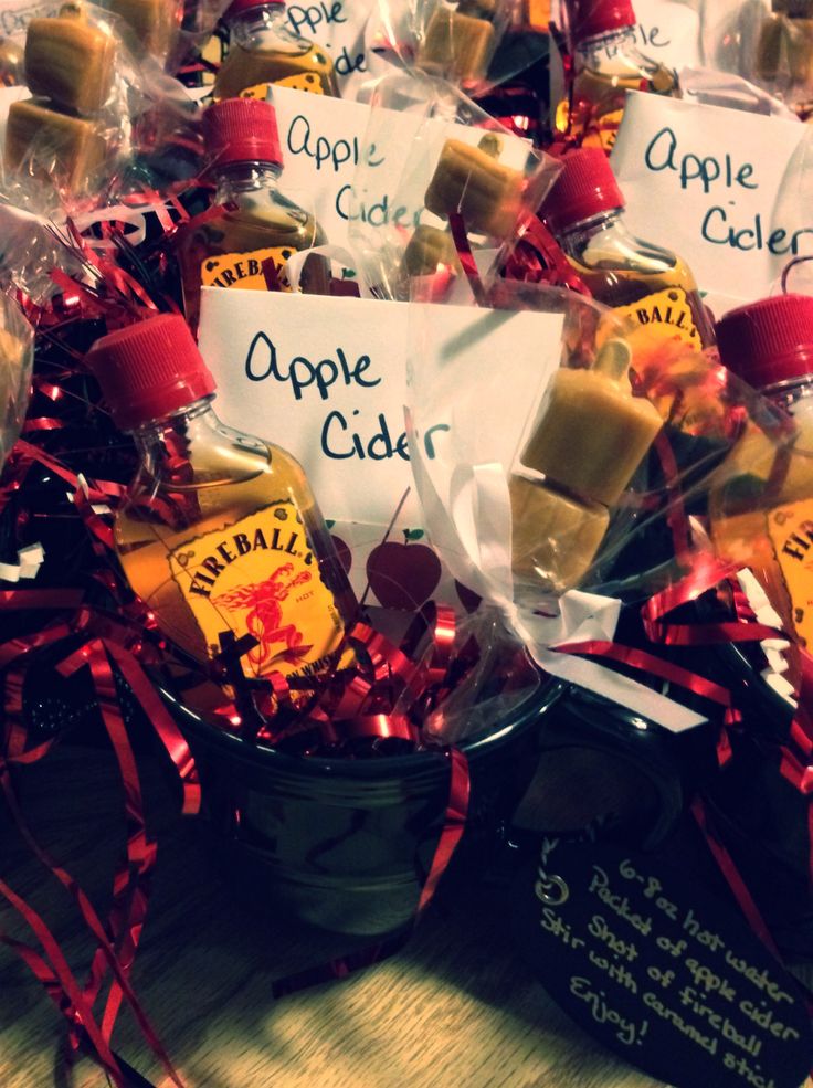 apples cider bottles wrapped in cellophane and tied with red ribbon