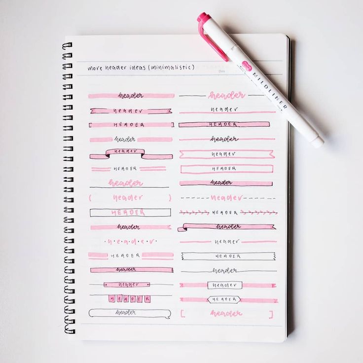 a notebook with pink ink and a pen on top