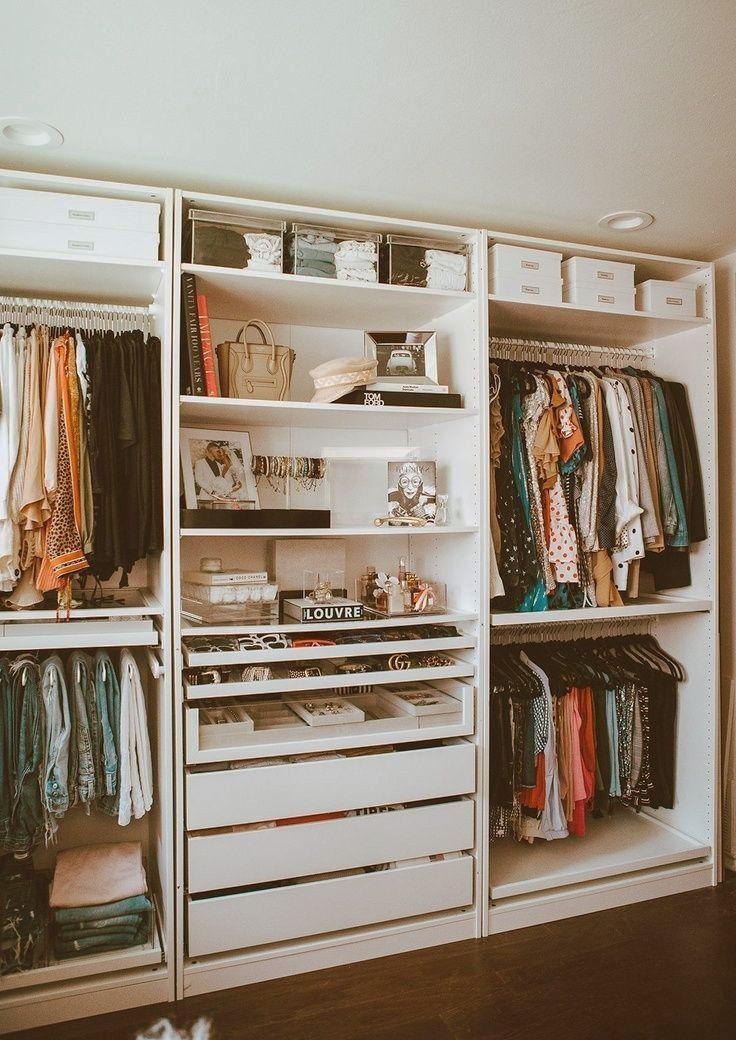 an organized closet with clothes and other items