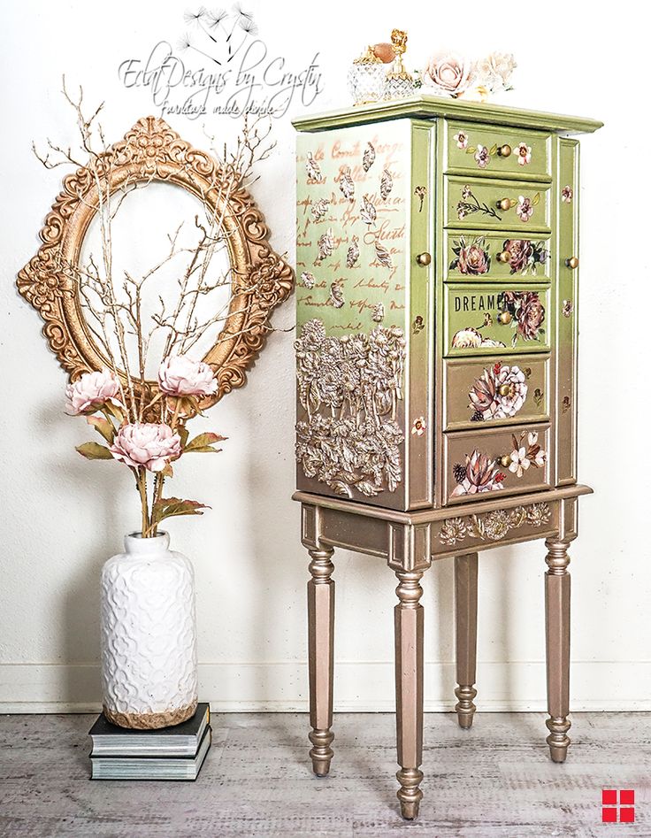 an ornate wooden cabinet next to a vase with flowers