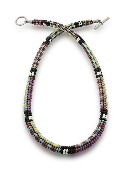 the multicolored beaded necklace is hanging from a hook on a white background