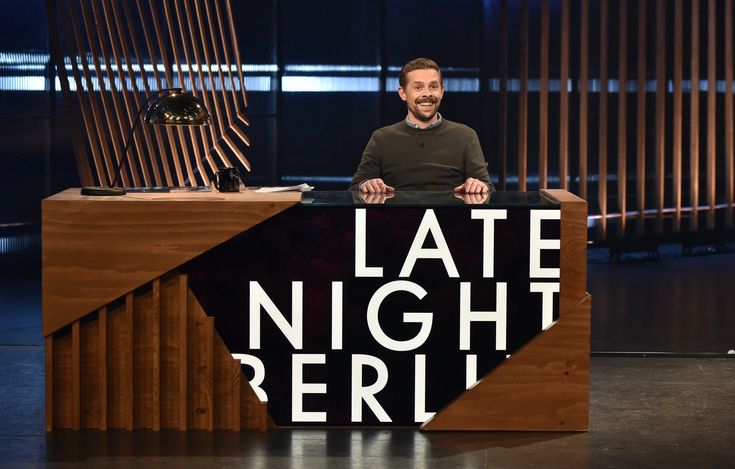 a man sitting in front of a desk with the words late night peru on it