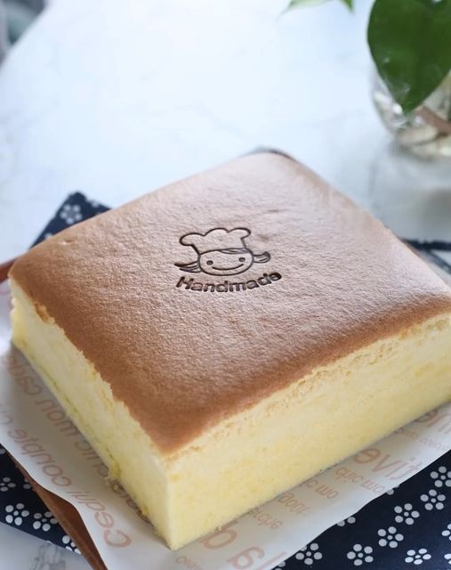 a piece of cake sitting on top of a table next to a potted plant