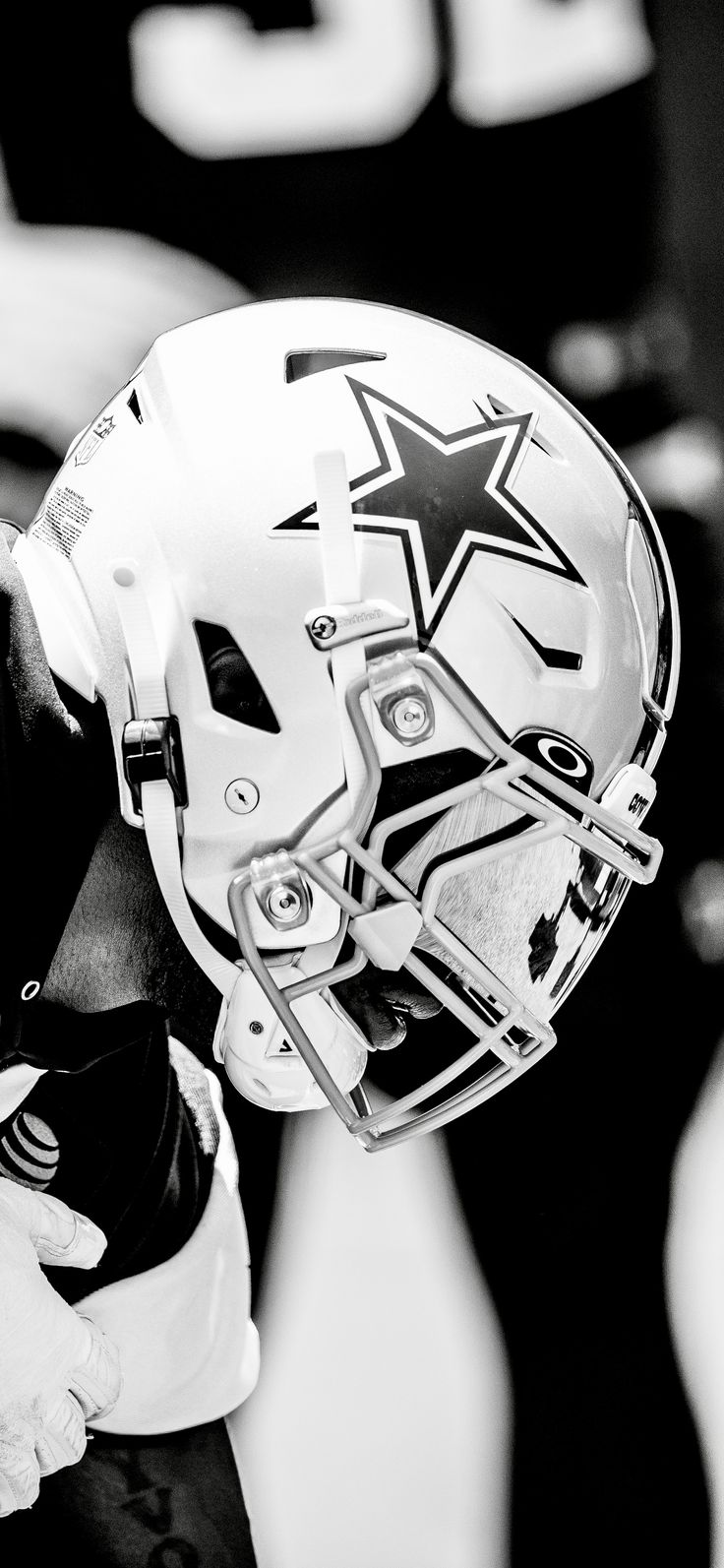 a black and white photo of a football player wearing a helmet with stars on it