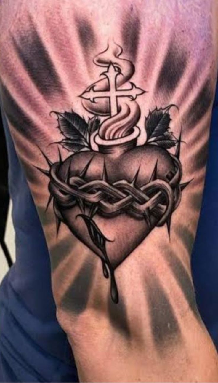 a man's arm with a heart and anchor tattoo on the back of it