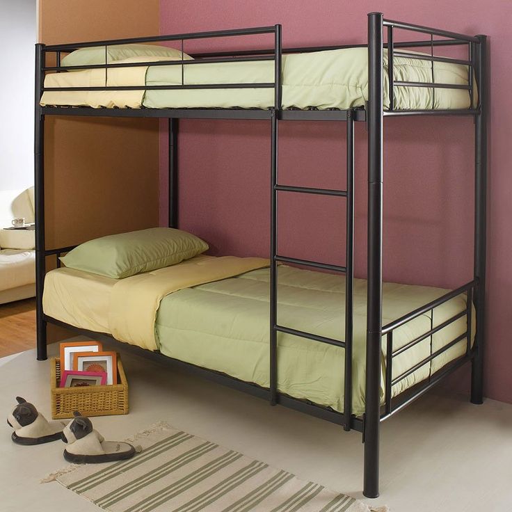 a bunk bed in a room with pink walls