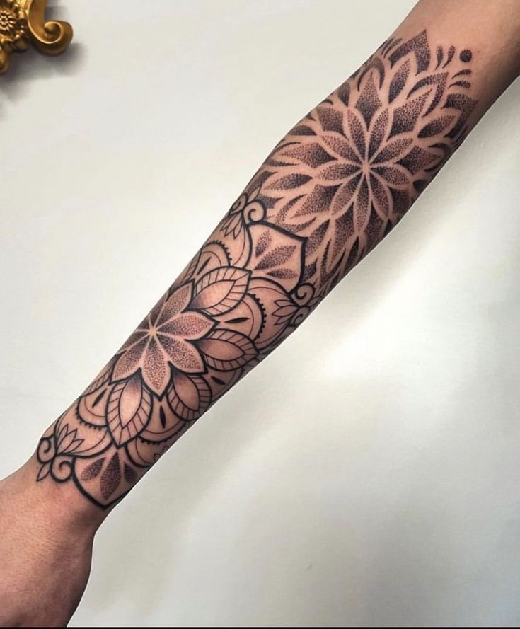 a woman's arm with a flower tattoo on it