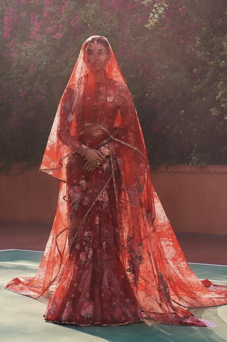 a woman in a red dress and veil