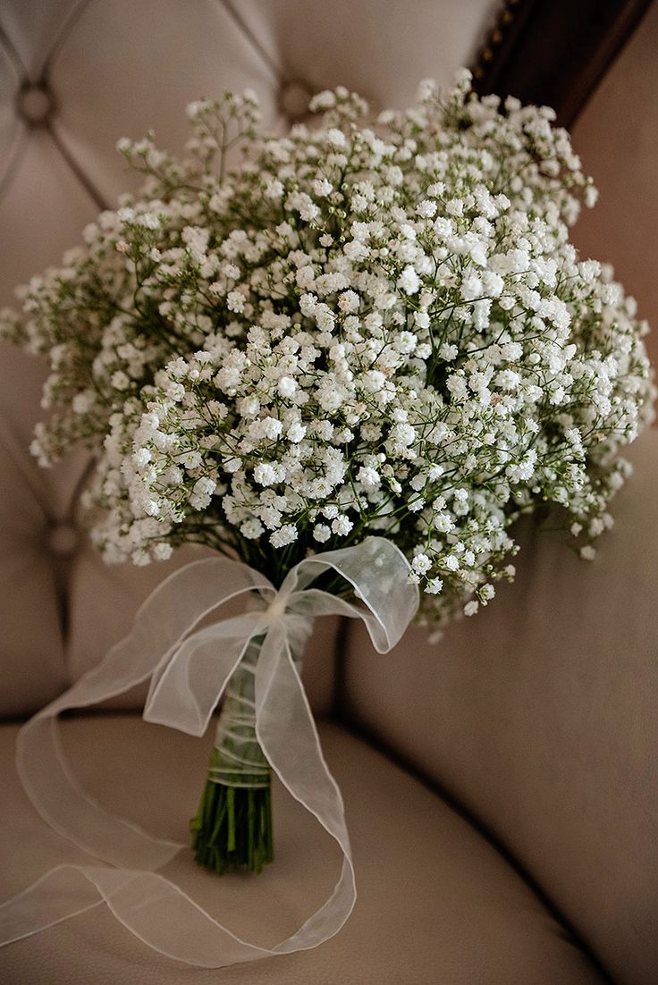 a bouquet of baby's breath sitting on top of a chair