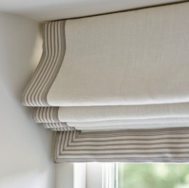 a close up of a window with roman blinds