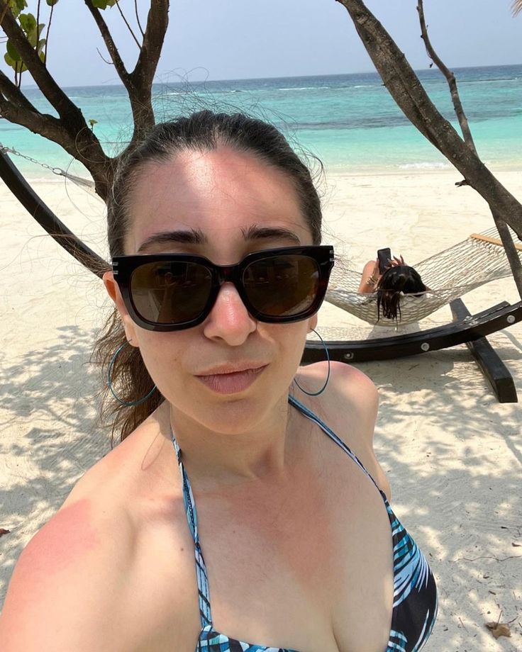 a woman wearing sunglasses on the beach