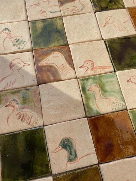 several birds painted on the ground in different colors