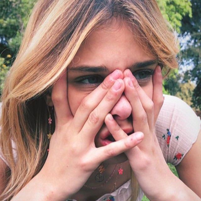 a girl covering her eyes with both hands