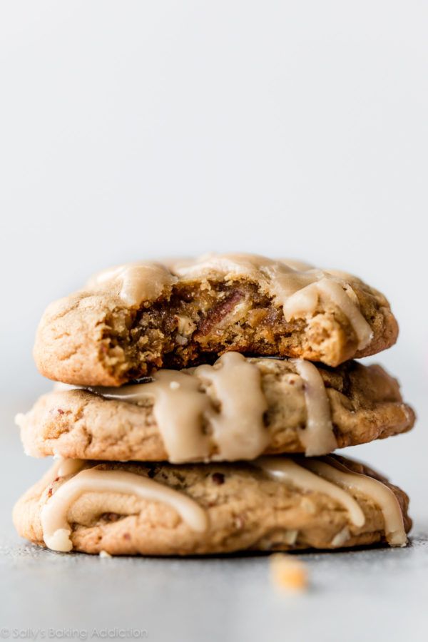 three cookies stacked on top of each other with icing drizzled over them