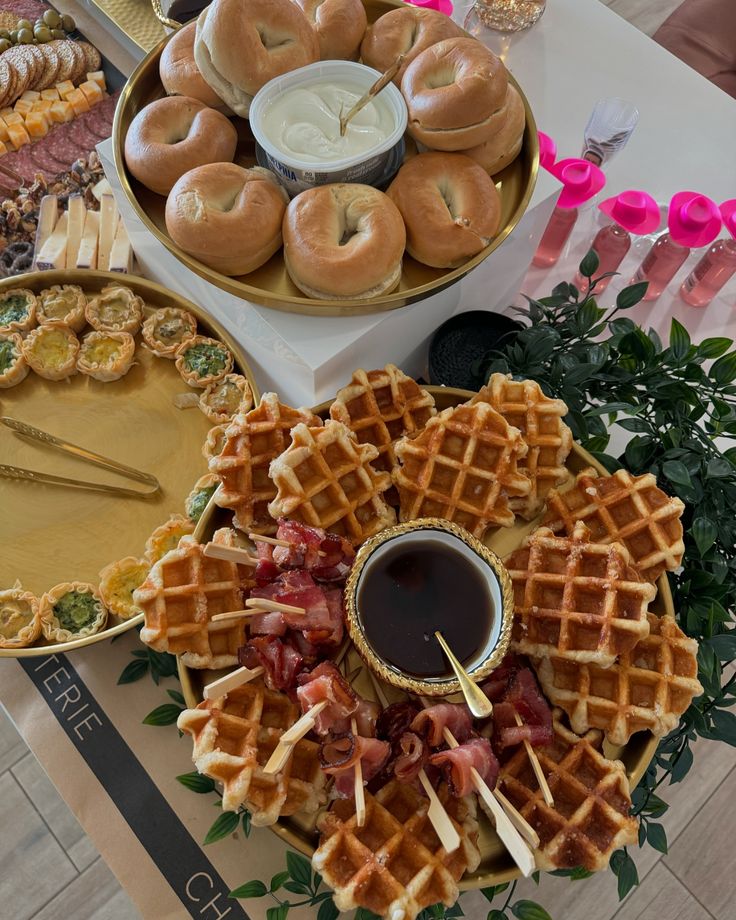 a table topped with lots of different types of waffles and other food items