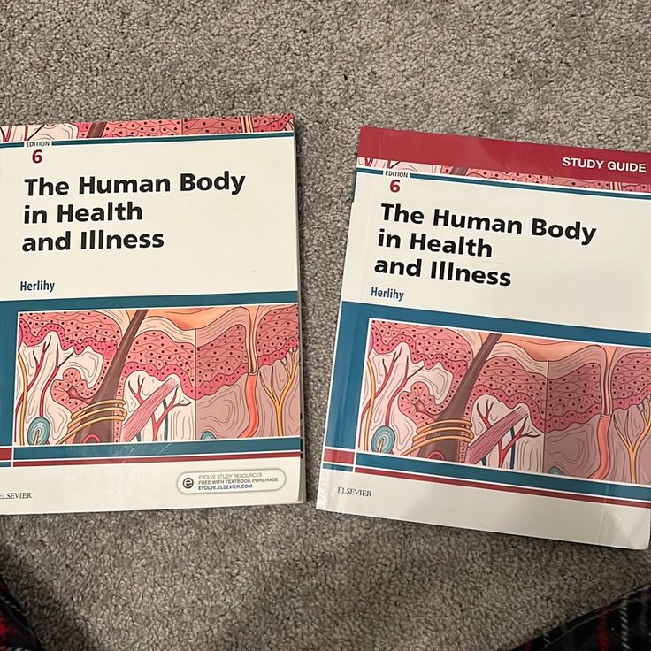 two books about the human body in health and fitness sitting on top of a carpet