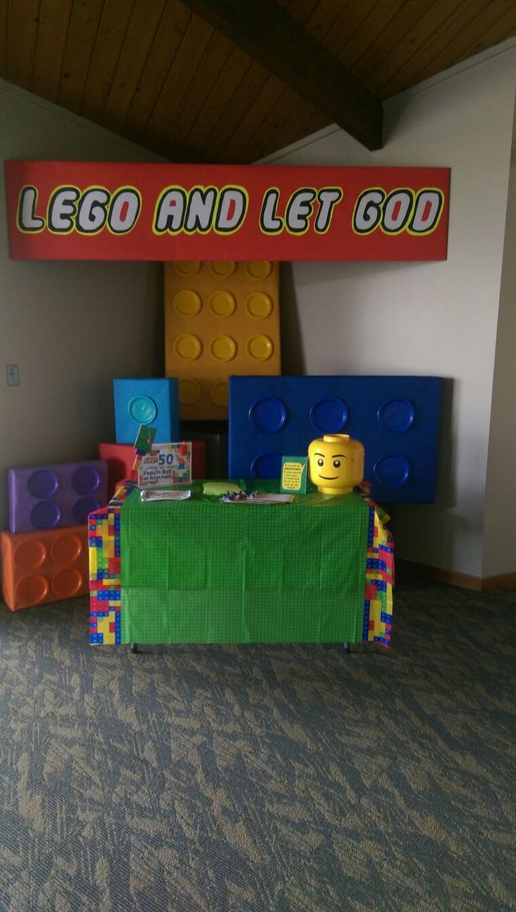 a table with legos on it in front of a sign that says lego and let go