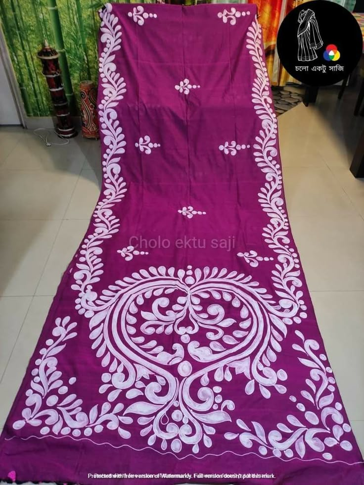 the purple and white sari is on display