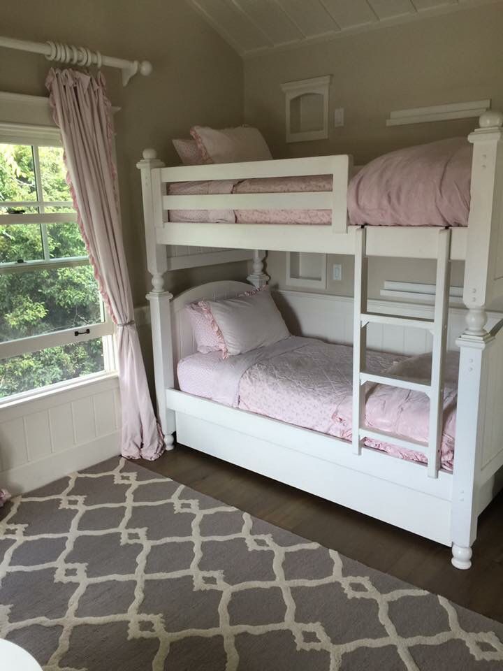 a bedroom with bunk beds in it and a rug on the floor next to them