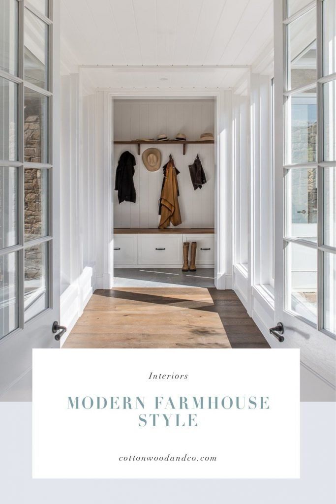 an entry way with white walls and wooden flooring is featured in the article modern farmhouse style