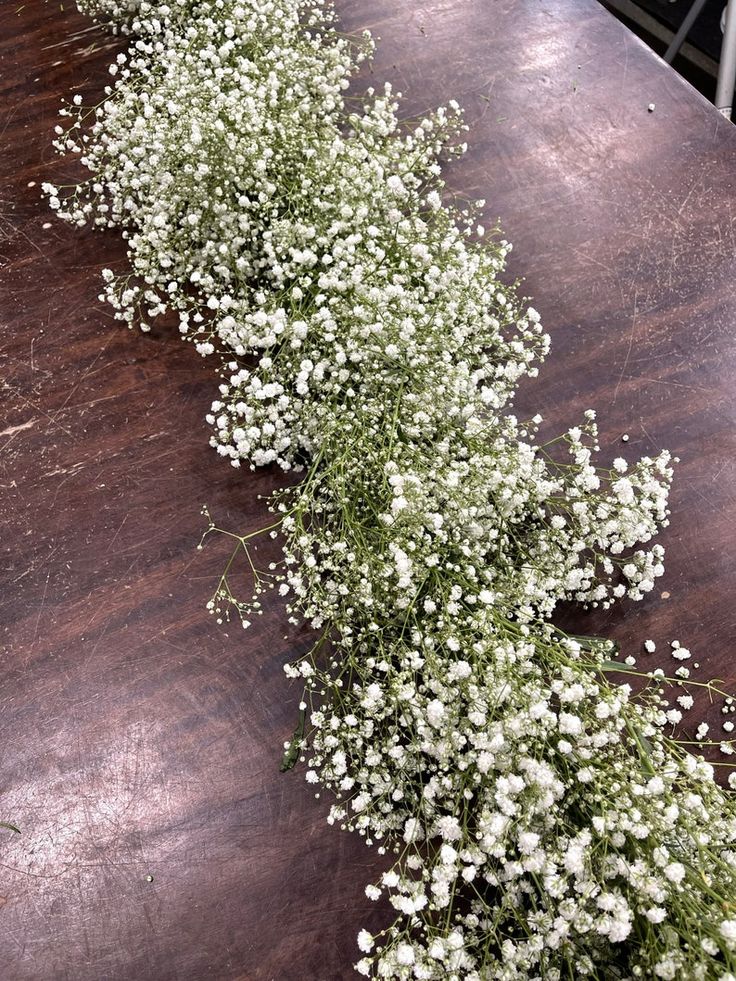 baby's breath flowers on a wooden table