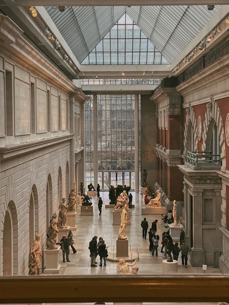 the inside of a museum filled with lots of statues