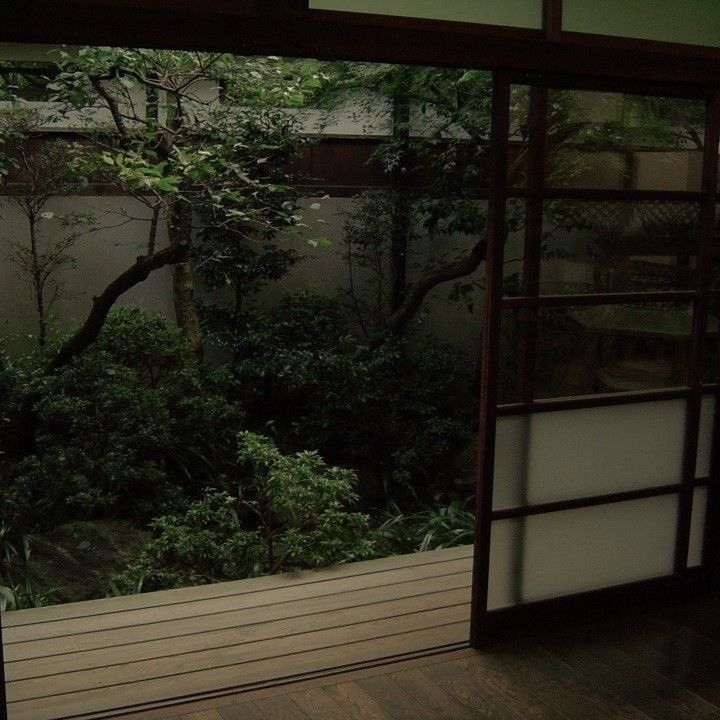 an open door leading to a lush green forest