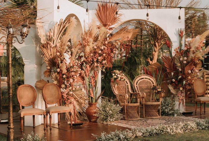 an outdoor area with chairs, tables and flowers