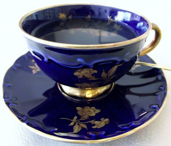 a blue cup and saucer sitting on top of each other