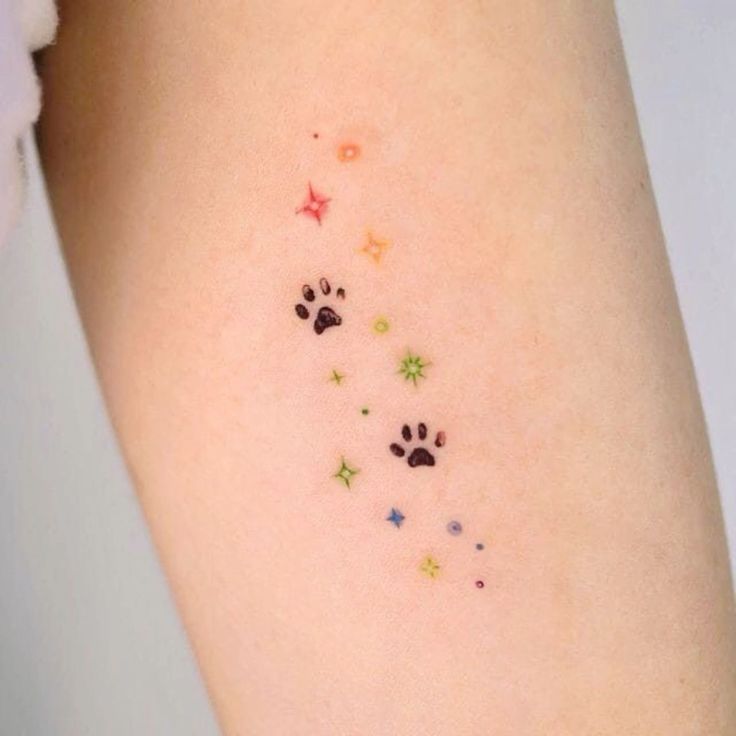 small paw prints on the left side of the right arm, with stars and dog's footprints