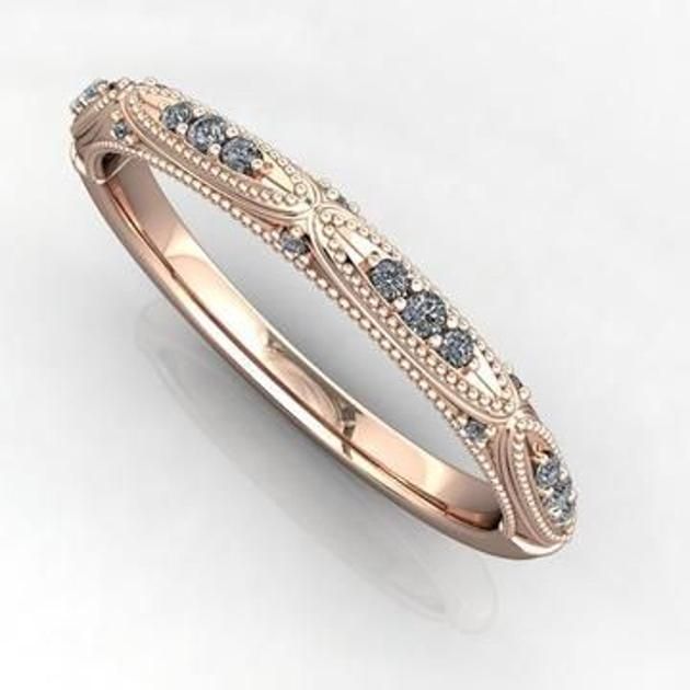 a wedding band with blue and white diamonds on it's sides, set in 18k rose gold