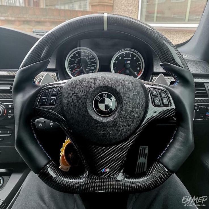 the interior of a car with steering wheel and dashboard