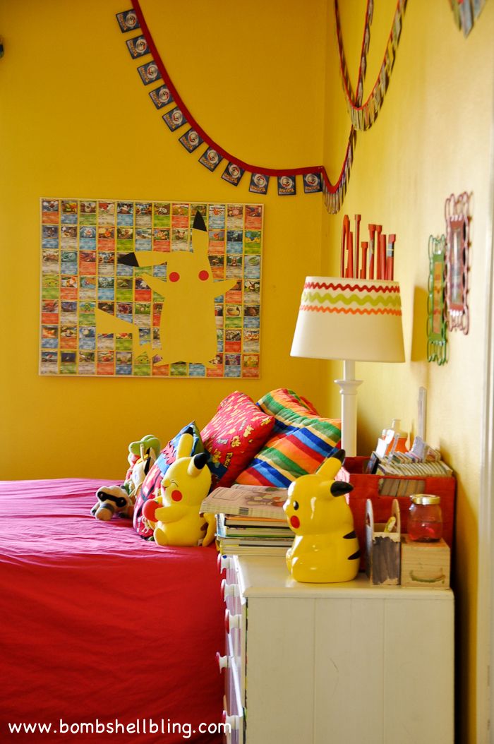 a bed room with a neatly made bed next to a lamp and pictures on the wall