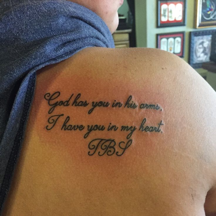 a person with a tattoo on their arm that says god has you in his arms