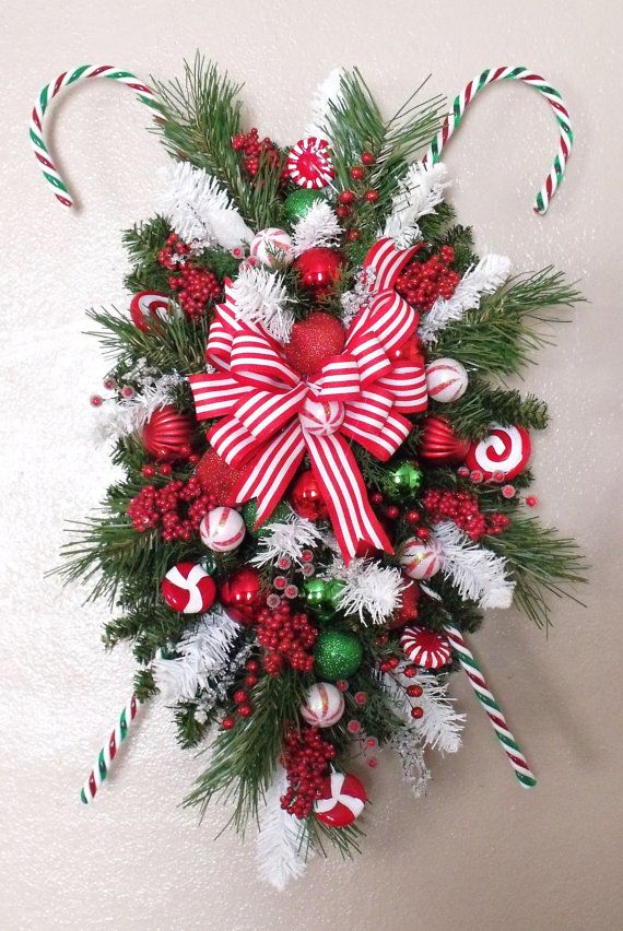 a christmas wreath with candy canes and decorations