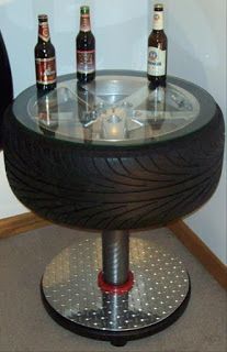 there is a glass table with four beer bottles on it and two wheels attached to the base