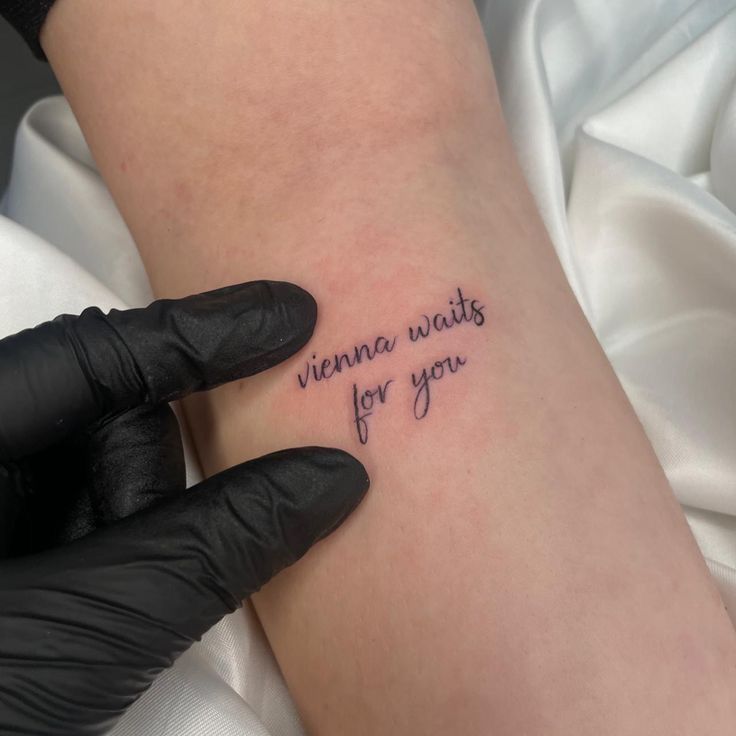 a woman's arm with the words virginia waits for you tattooed on it