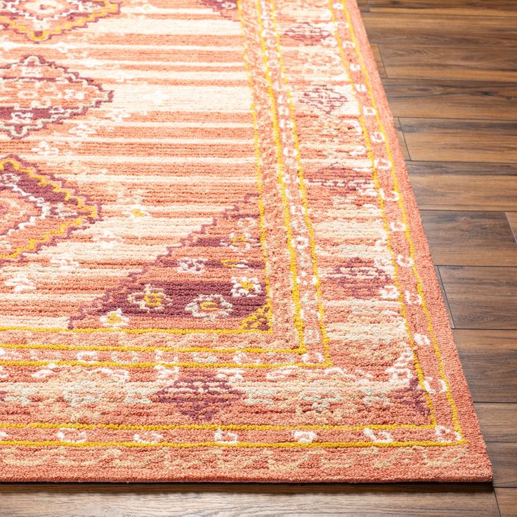 an orange and pink rug on the floor