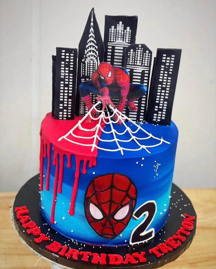 a spiderman themed birthday cake on a table