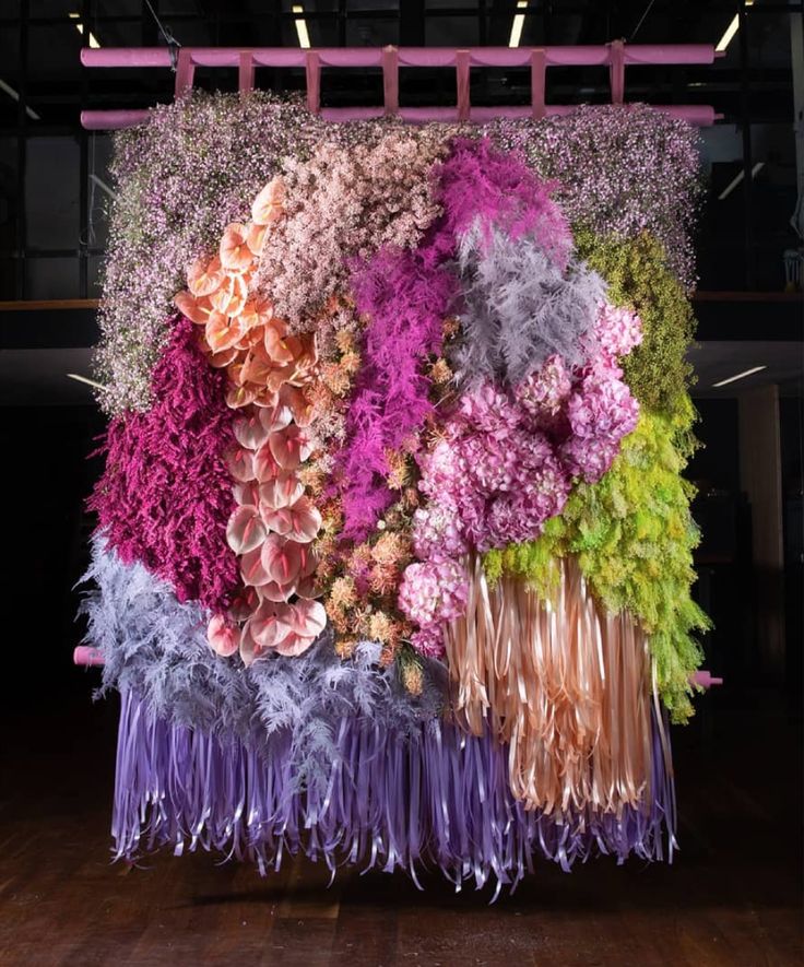 a large piece of art made out of flowers and feathers