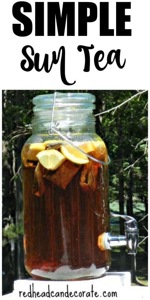 a mason jar filled with tea and lemon slices