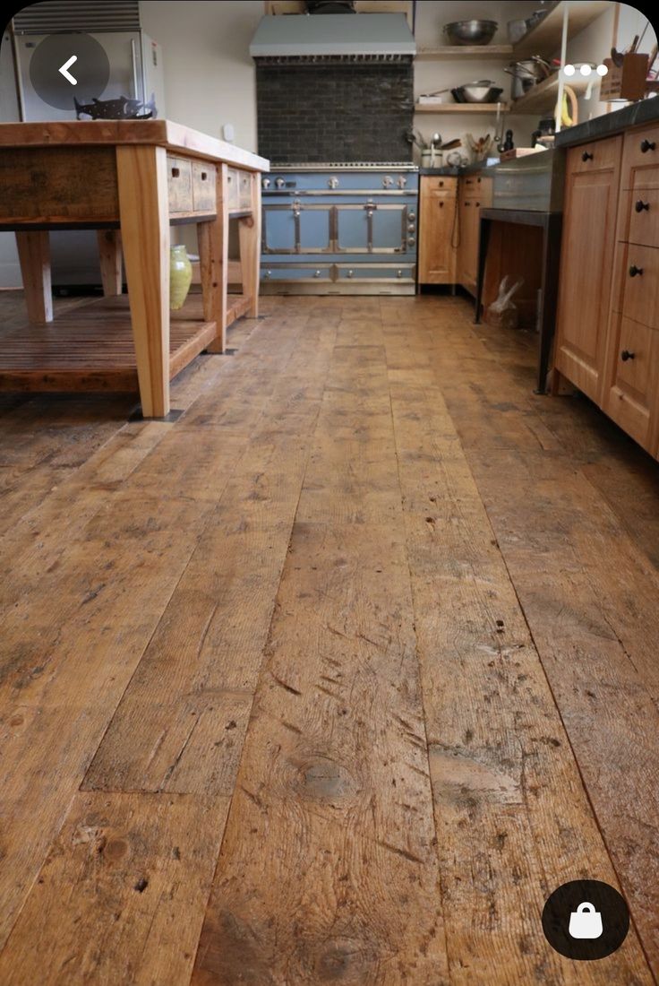 a large kitchen with wooden floors and cabinets