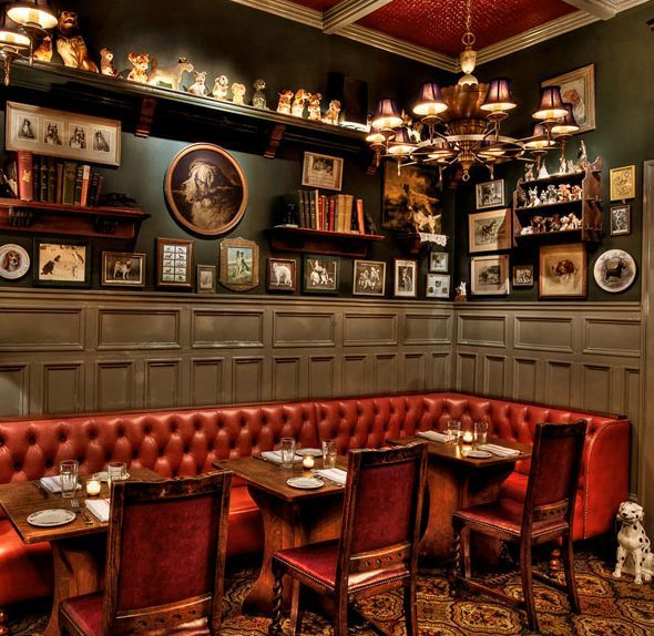 a restaurant with red leather booths and pictures on the wall