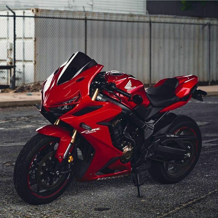 a red motorcycle is parked on the street