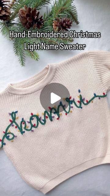 an embroidered christmas sweater with the word merry written on it and pine cones in the background